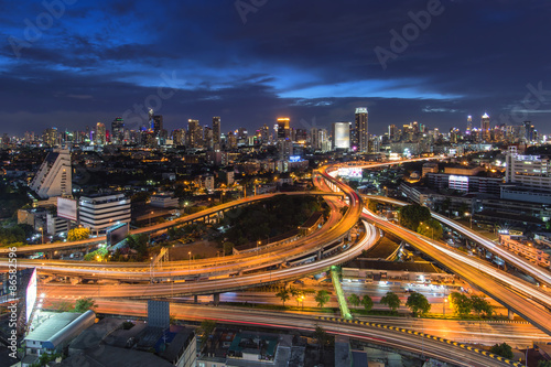 Bangkok nightscape / a scene of traffic trail lights on highways at night in the middle of Bangkok City, Thailand