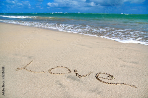 Sign Love on sand on beach
