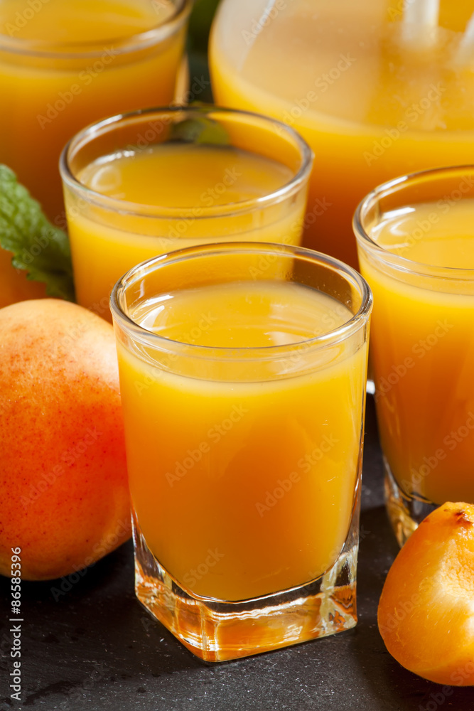 Fresh apricot juice and apricots with mint on black background, Fresh apricot juice and apricots with mint on black background,