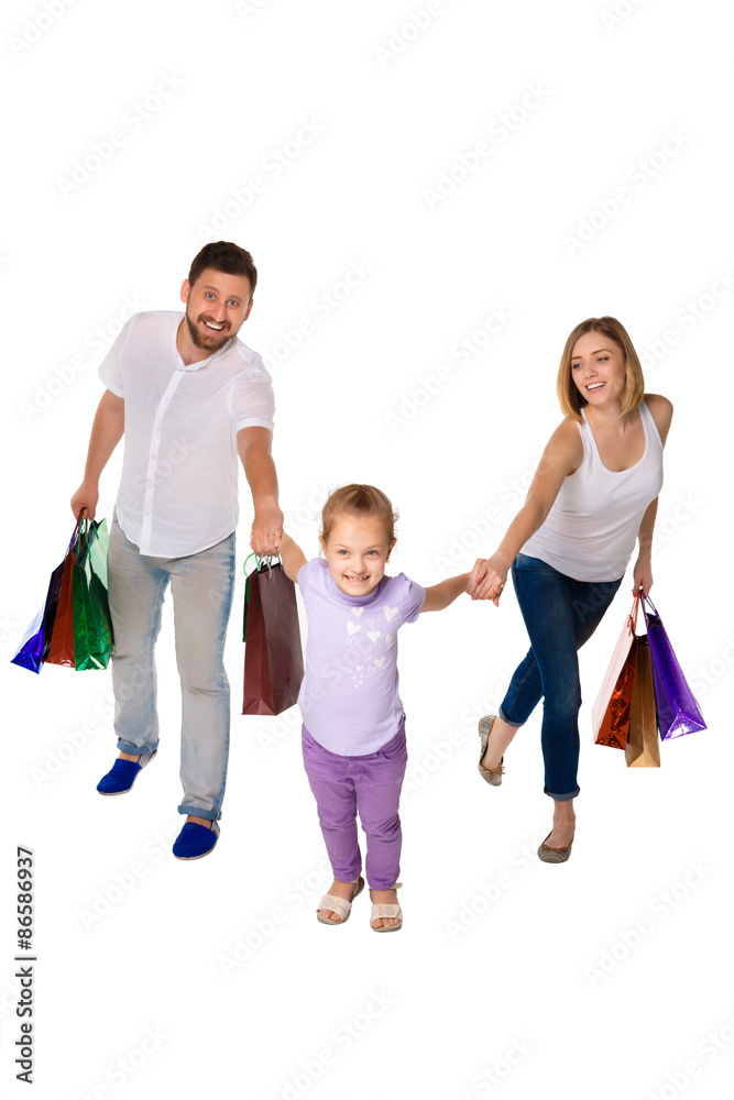 Happy family with shopping bags standing at studio Happy family with shopping bags standing at studio