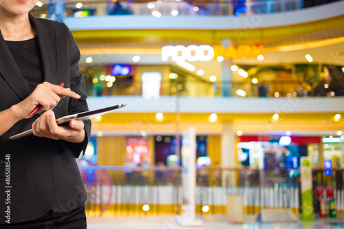 Businesswoman using digital tablet in the shopping mall.