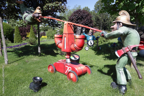 Two firefighters pump water pump