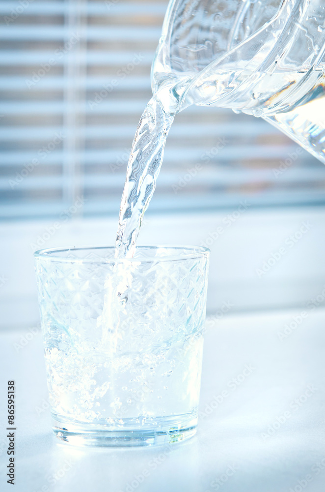 Pour water from a pitcher into a glass Pour water from a pitcher into a glass