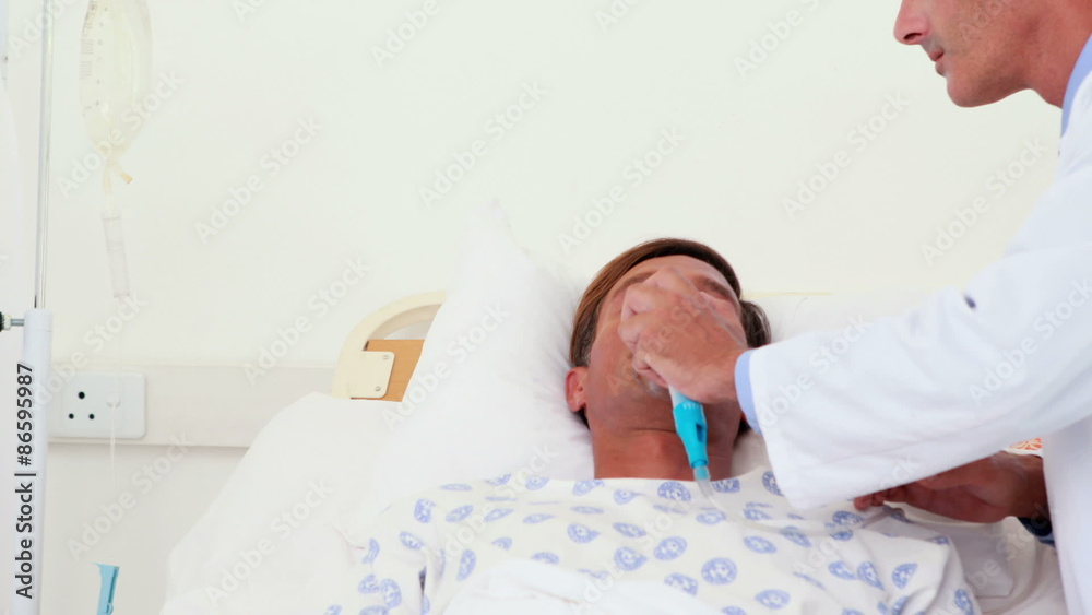 Doctor putting oxygen mask on patient head