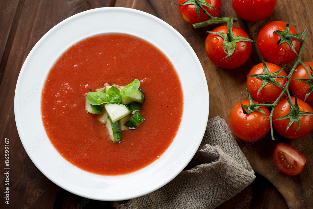Gazpacho with cucumber and green basil topping, above view Gazpacho with cucumber and green basil topping, above view
