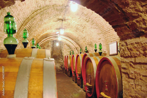 Vault with wine casks. Montepulchano, Tuscany, Italy photo