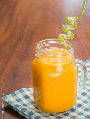 Iced milk tea on wooden background.