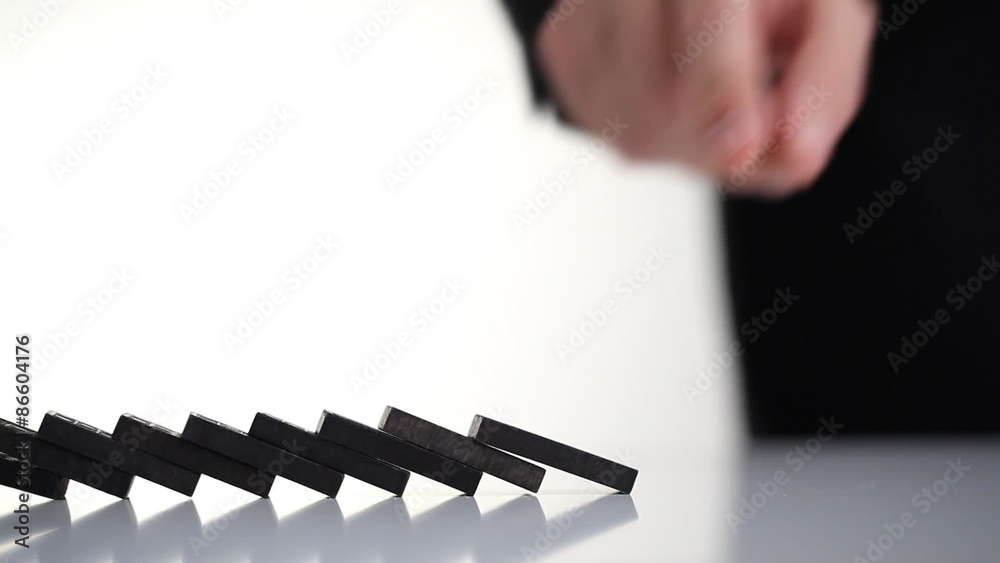 Hand starting a row of dominoes; entrepreneur or start-up concept