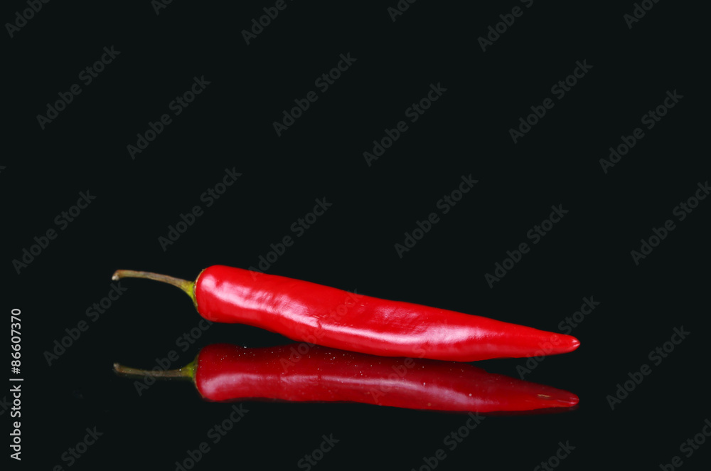 Red hot pepper and reflection on black background Red hot pepper and reflection on black background
