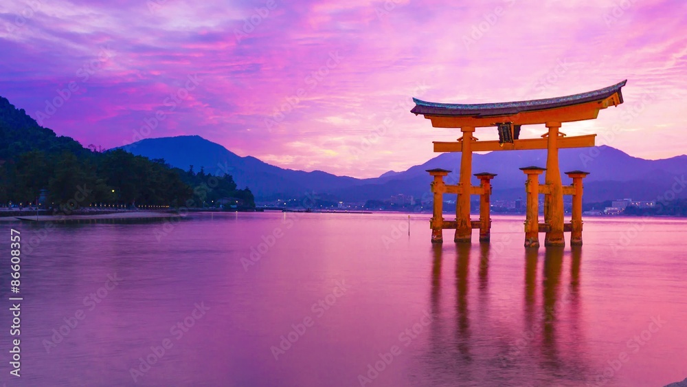 Sunset time-lapse of the famous orange shinto gate (Torii) of Miyajima island of Hiroshima prefecture, Japan. Sunset time-lapse of the famous orange shinto gate (Torii) of Miyajima island of Hiroshima prefecture, Japan.
