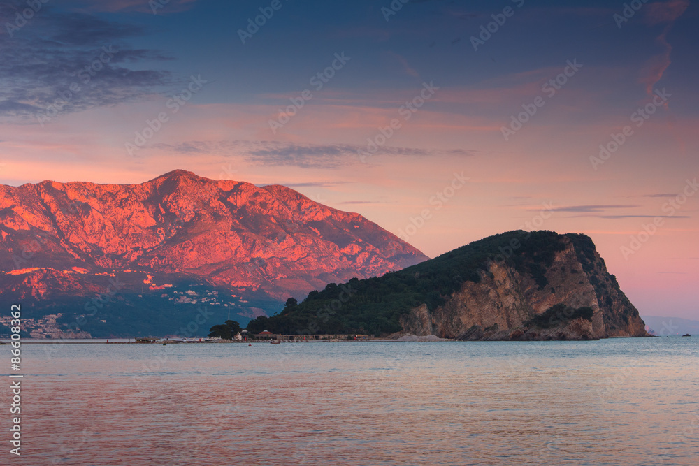 Landscape of coast: Sveti Nikola island and mountains at sunset . 
