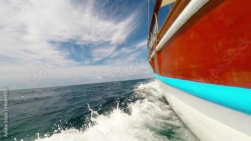 sailing boat rushing trough the blue ocean photo