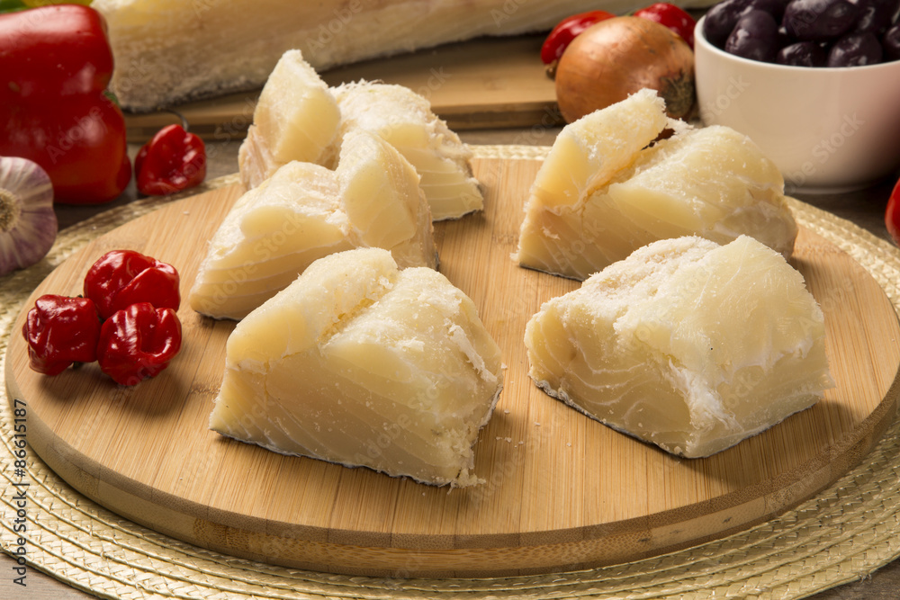 salted codfish on the wooden table with ingredients salted codfish on the wooden table with ingredients