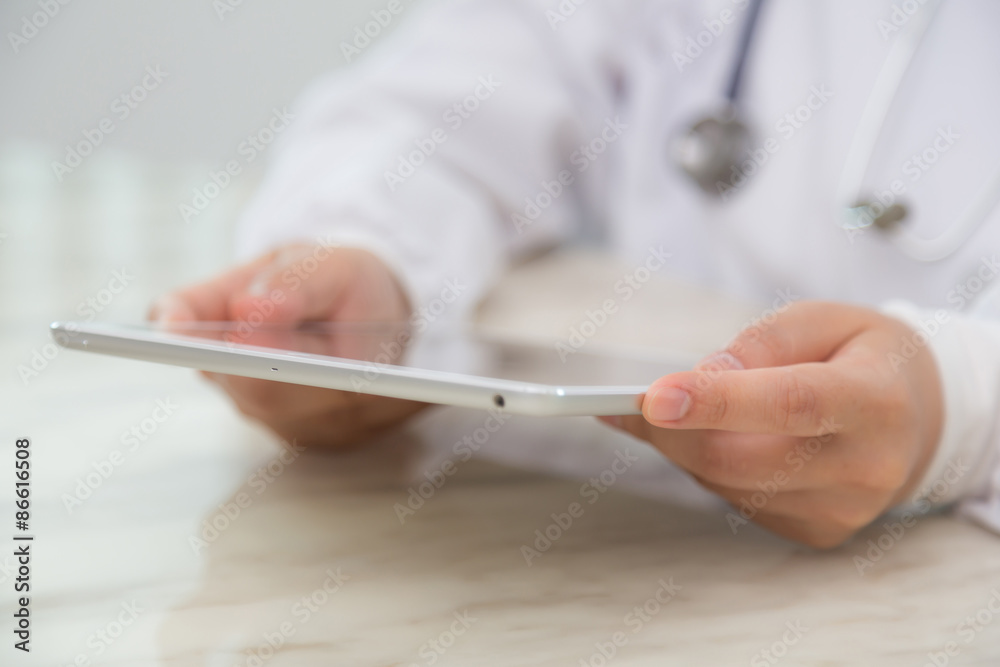 Doctor using tablet computer Doctor using tablet computer