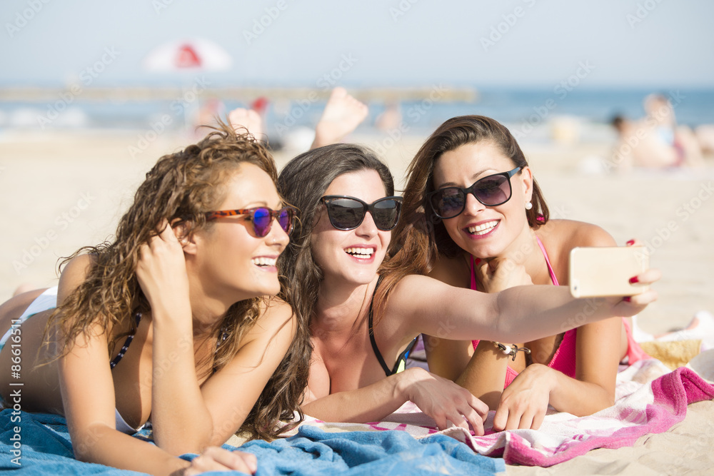 Fototapeta premium Three friends at the beach getting a selfie