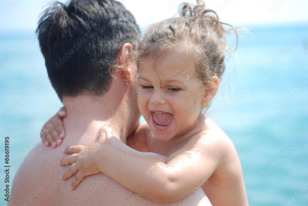 happy little girl hugging embracing her father happy little girl hugging embracing her father