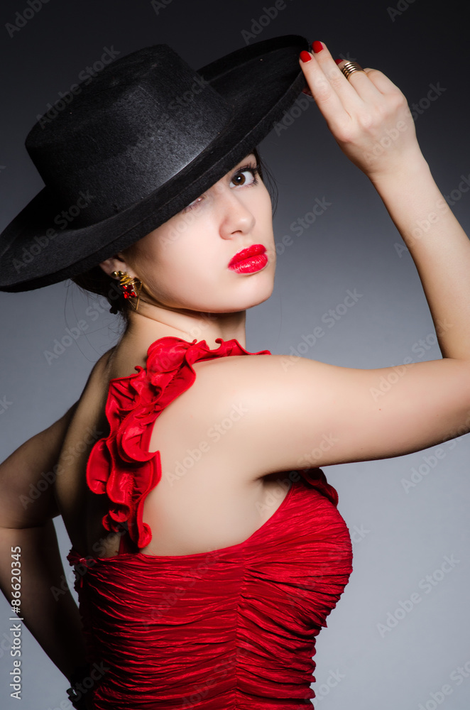 Fototapeta premium Woman wearing hat against dark background