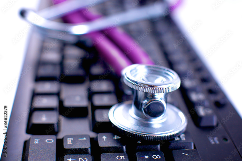 Violet stethoscope on a laptop computer Violet stethoscope on a laptop computer