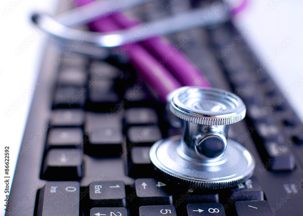 Violet stethoscope on a laptop computer Violet stethoscope on a laptop computer