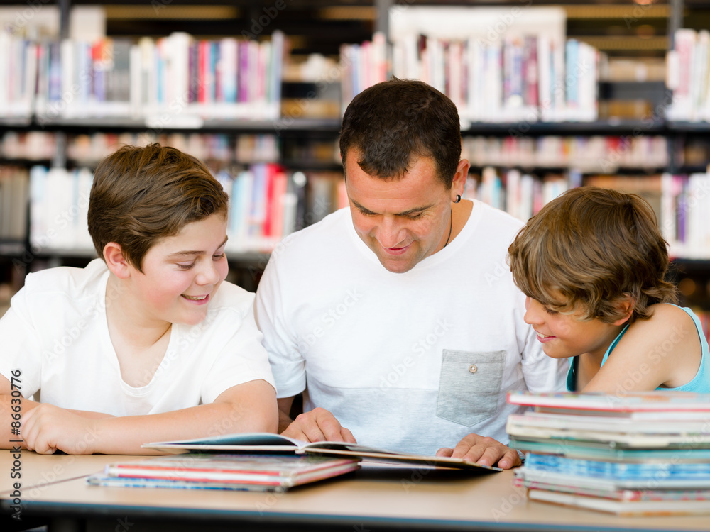 Father with sons in library Father with sons in library