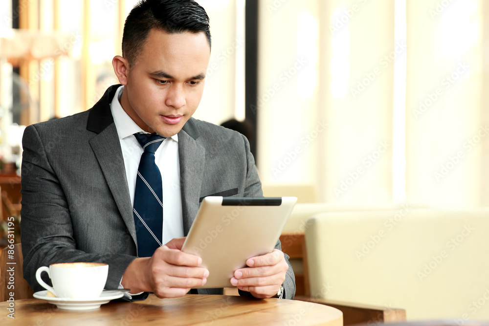 businessman reading an article on his tablets businessman reading an article on his tablets