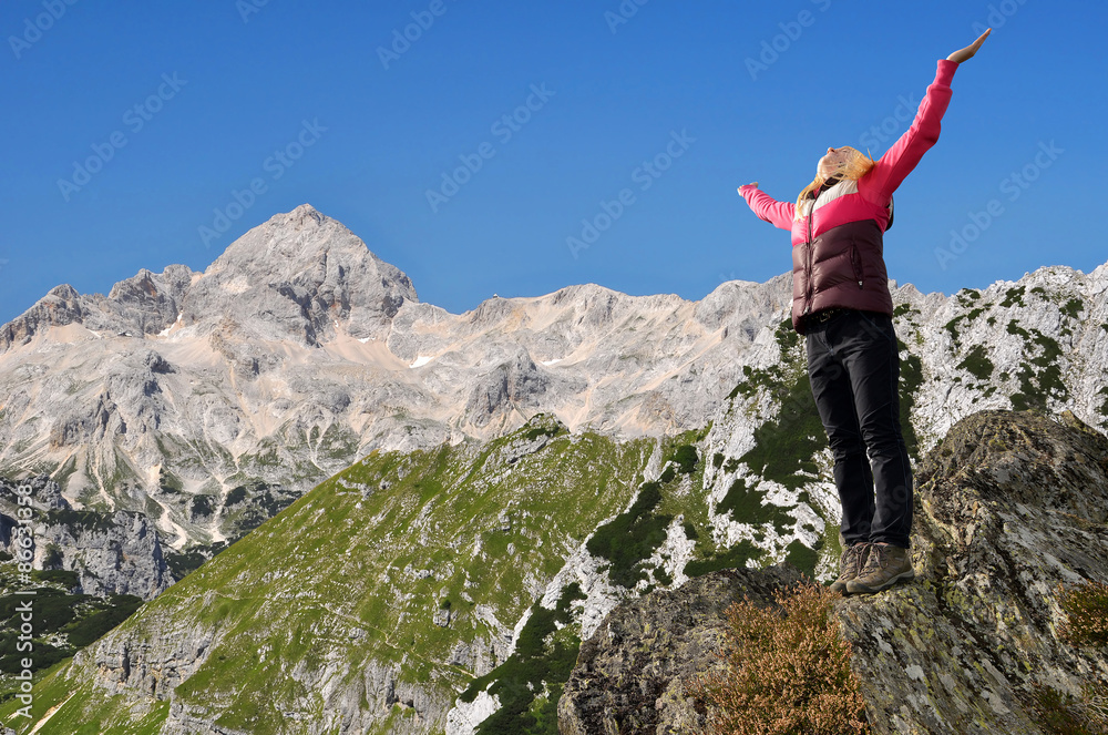 Girl on rock, in the background mount Triglav - Julian Alps, Slovenia 