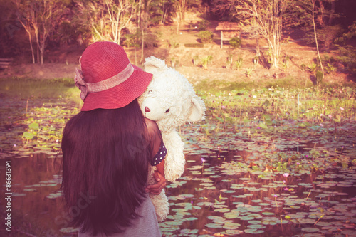 Wallpaper Mural asian cute girl standing alone at the lagoon and hand bear hug,vintage tone Torontodigital.ca