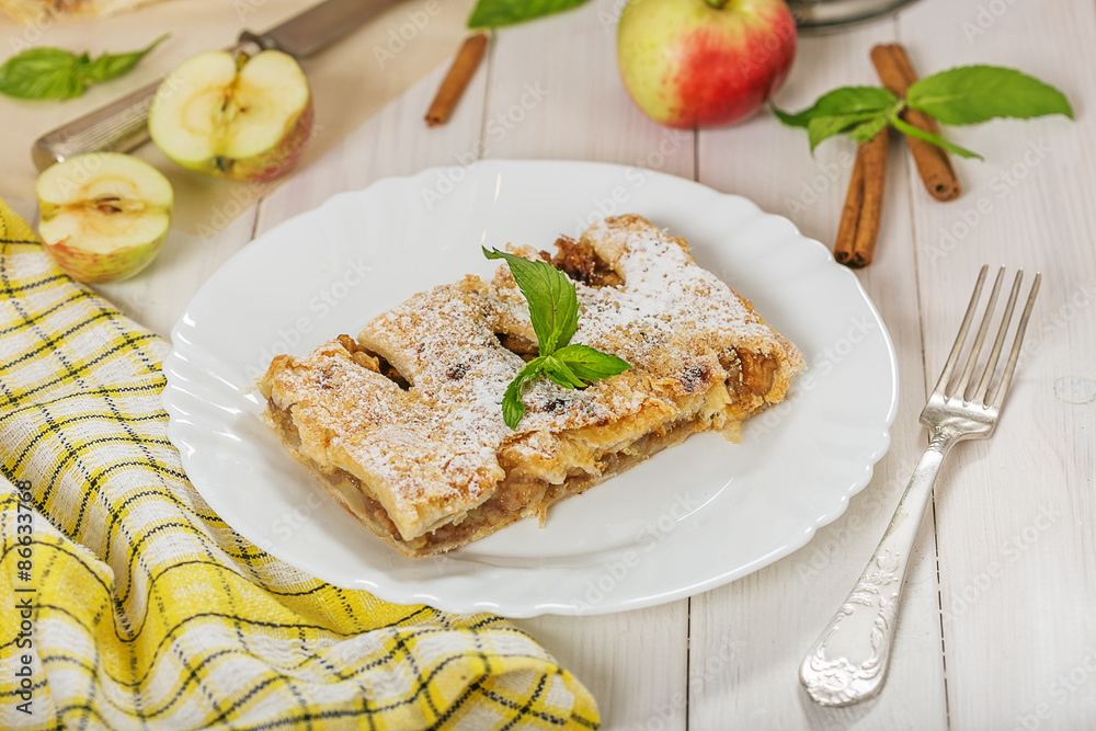 Piece of the pie of puff pastry with apple and cinnamon