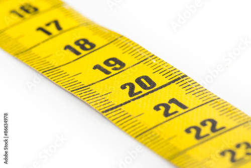 Yellow measuring tape isolated - selective focus