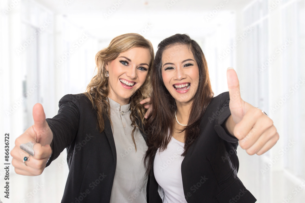 young business woman making thumbs up gesture wearing blouse and young business woman making thumbs up gesture wearing blouse and