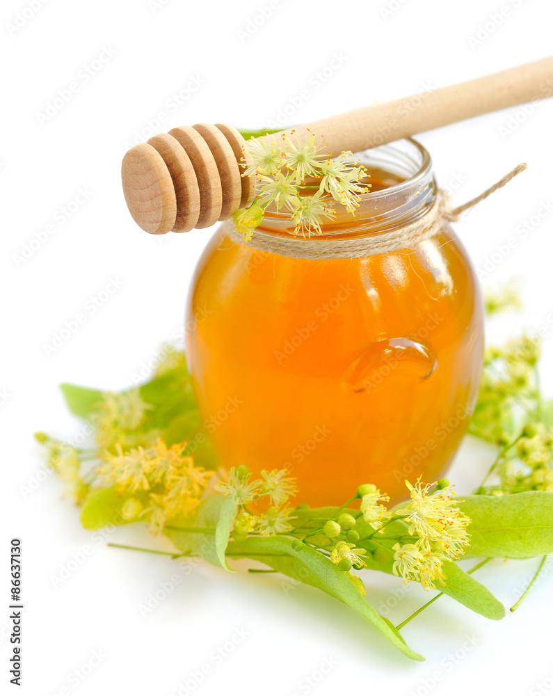 jar of fresh honey with flowers of linden on white background jar of fresh honey with flowers of linden on white background