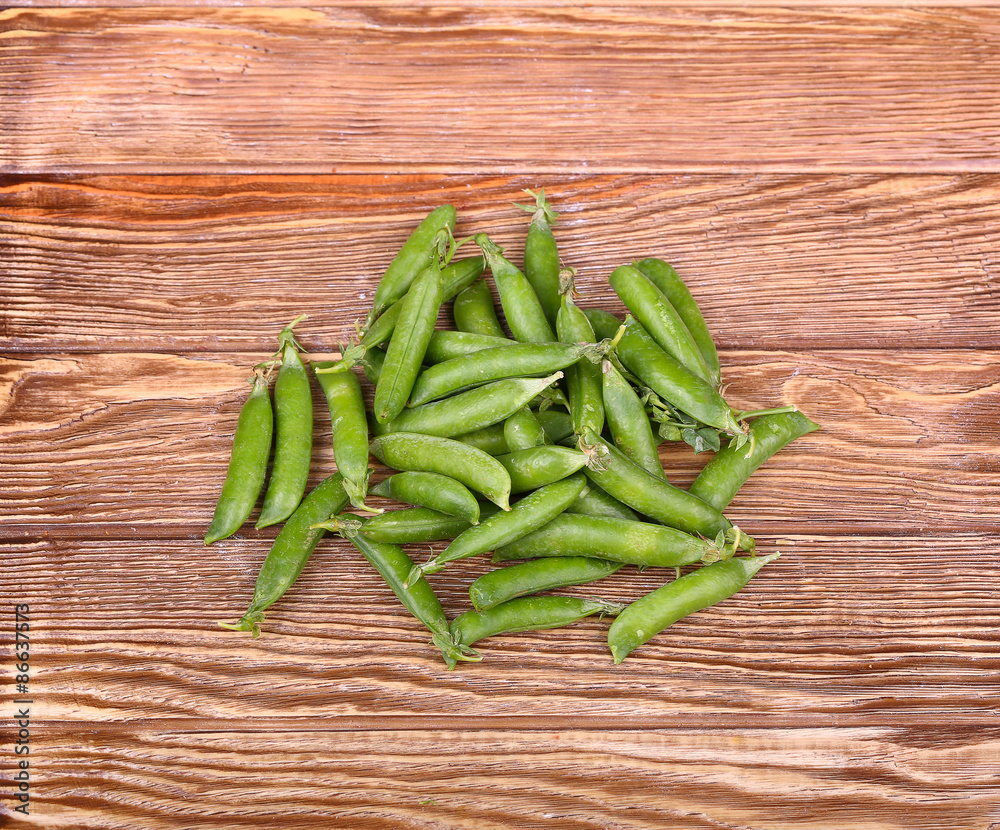 Green peas on wooden background.top view Green peas on wooden background.top view