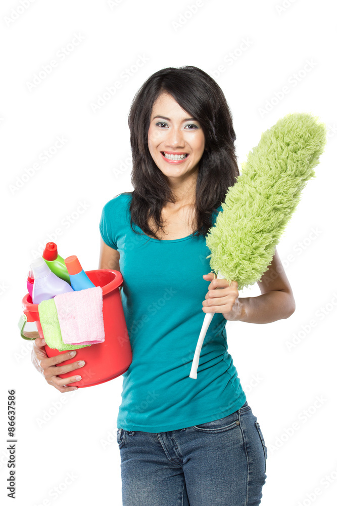 woman holding a basket full of cleaning products ready to do som woman holding a basket full of cleaning products ready to do som