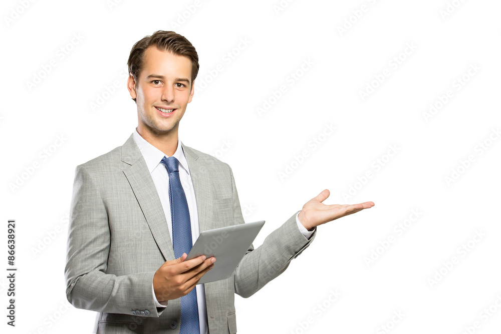 young businessman holding a tablet and presenting copyspace young businessman holding a tablet and presenting copyspace