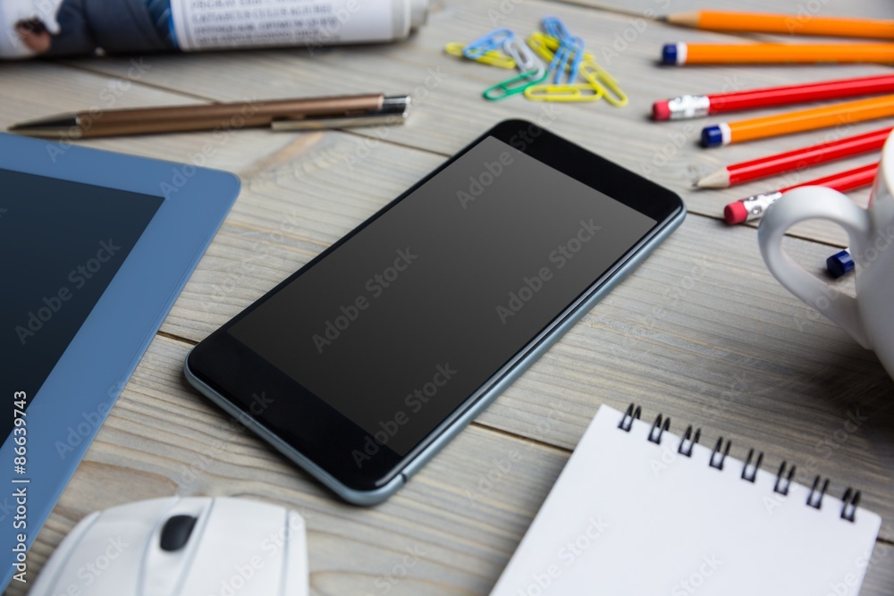 Smartphone next to the cup notepad tablet Smartphone next to the cup notepad tablet