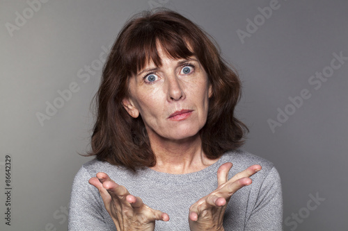 Cuadro en lienzo portrait of exasperated 50's woman losing faith with palm hands opened for anger