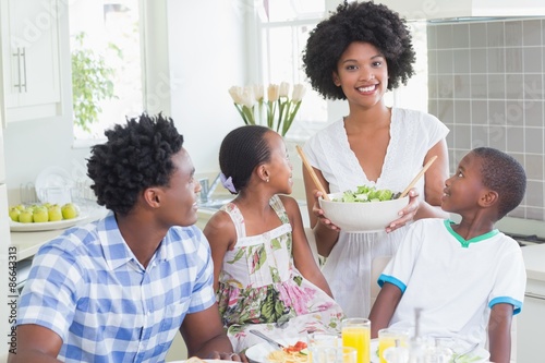 Happy family sitting down to dinner together