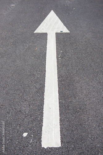 white arrow point on the road