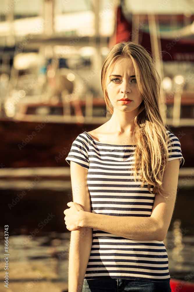 woman in marina against yachts in port woman in marina against yachts in port