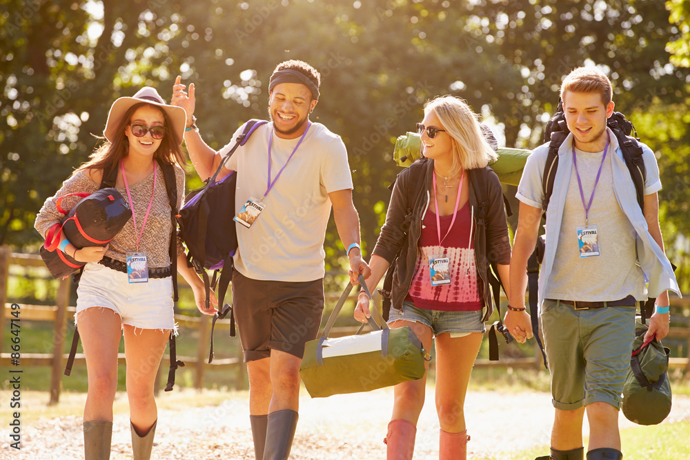 Obraz premium Group Of Young People Going Camping At Music Festival