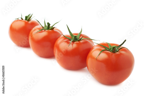 Four tomatoes in a line isolated