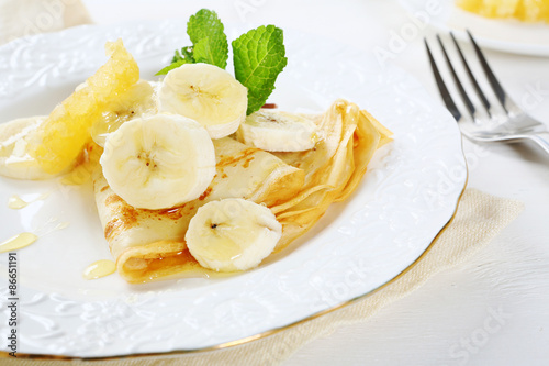 Pancakes with banana and honeycomb on a plate