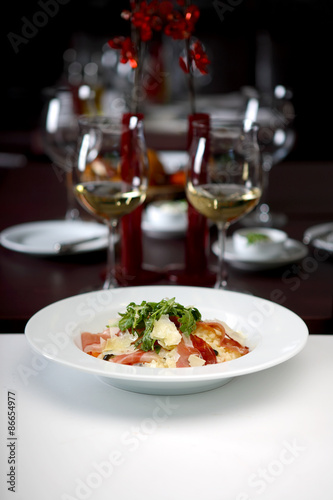 Pasta with prosciutto, arugula and Parmesan cheese, shallow depth of field, 