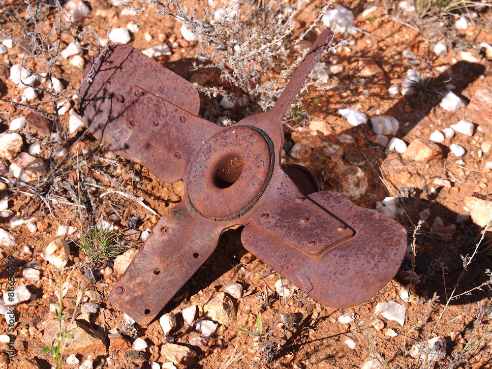 Rusted vehicle fan blades in the red desert sand of the outback near Alice Springs, Australia, July 2015 Rusted vehicle fan blades in the red desert sand of the outback near Alice Springs, Australia, July 2015