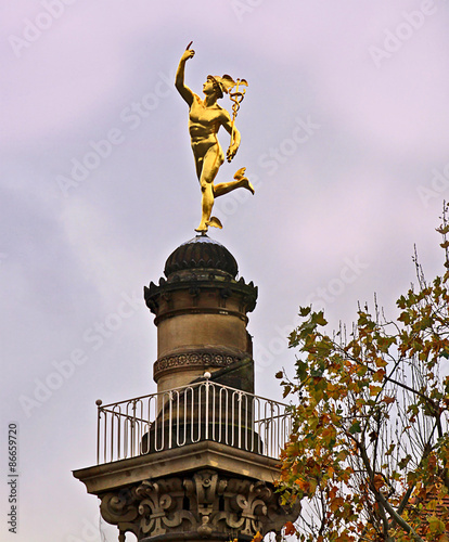 Stuttgart, Germany - golden Hermes statue on a column near Schlossplatz photo