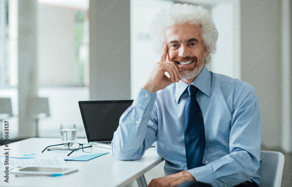 Fototapeta premium Confident businessman posing with hand on chin