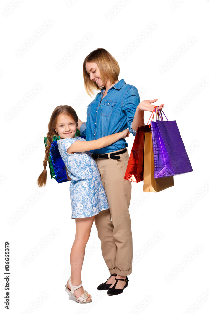 Happy mother and daughter with shopping bags standing at studio Happy mother and daughter with shopping bags standing at studio
