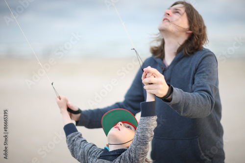 Daddy with his son launching a kite