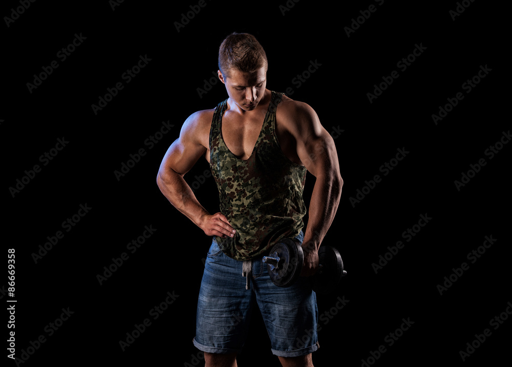 Handsome muscular bodybuilder posing over black background. Handsome muscular bodybuilder posing over black background.