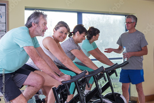 Group of seniors using spinning bikes